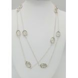 A Green Amethyst Rope- Length Chain. Oval faceted amethysts set in 925 Sterling Silver. 48cwt.