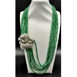 An impressive, six row necklace with faceted emerald beads and highly ornamental, white metal (