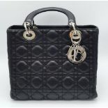 The Season's Lady Dior bag by Christian Dior is crafted from black quilted Lambskin leather. The