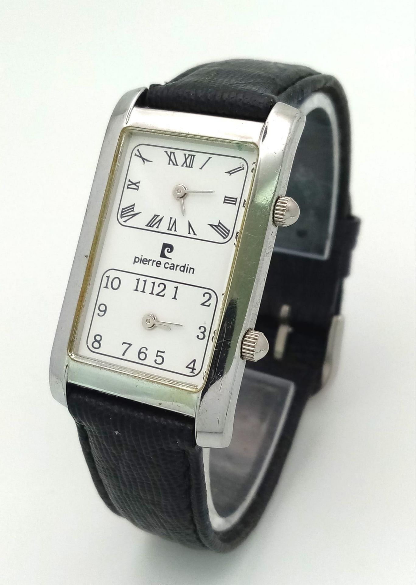 A Vintage Pierre Cardin Dual Time Quartz Watch. Black leather strap. Elongated case. In working