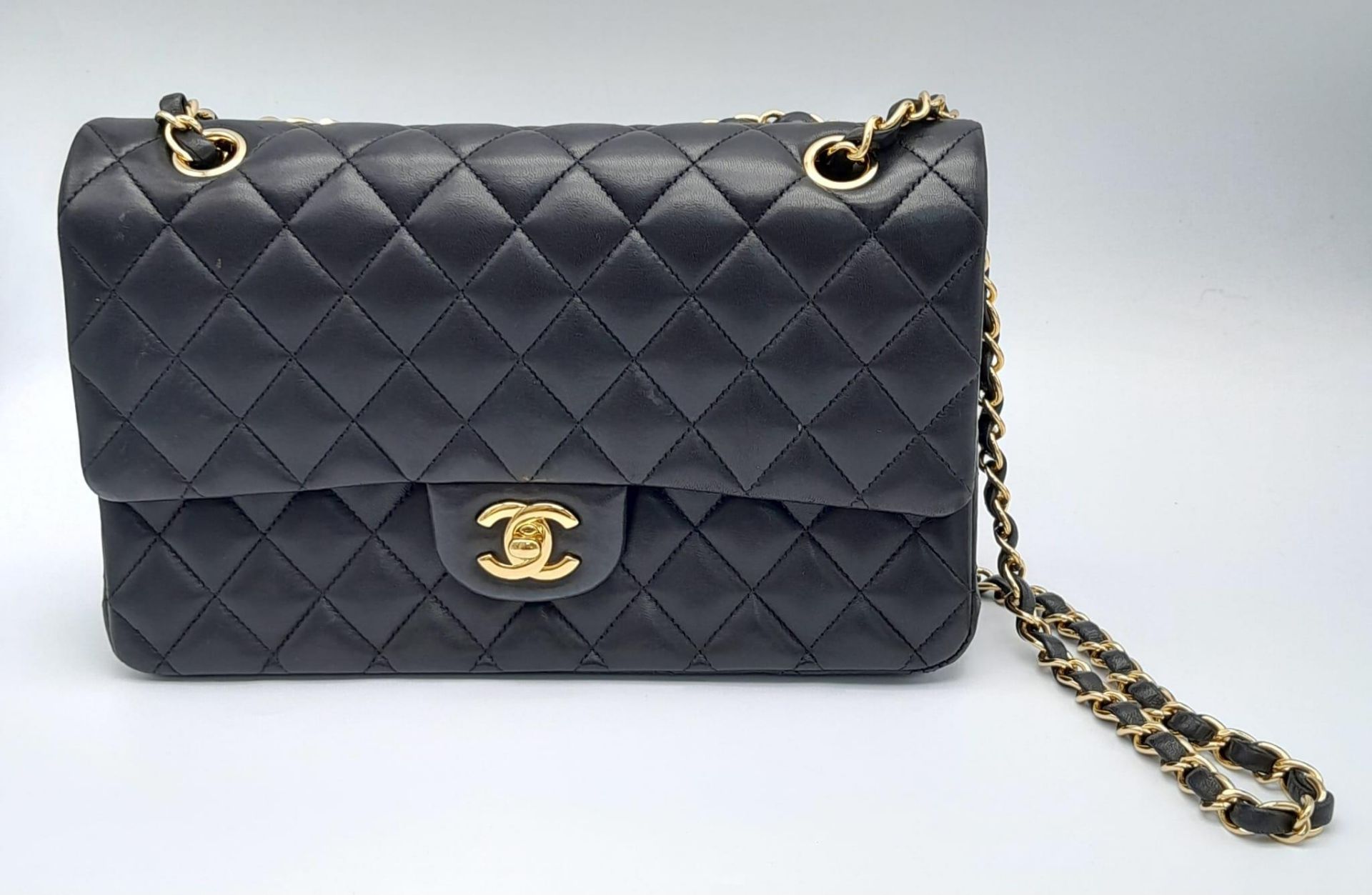 A Classic Chanel Double Flap Bag. Quilted lambskin black leather exterior with gilded Chanel logo