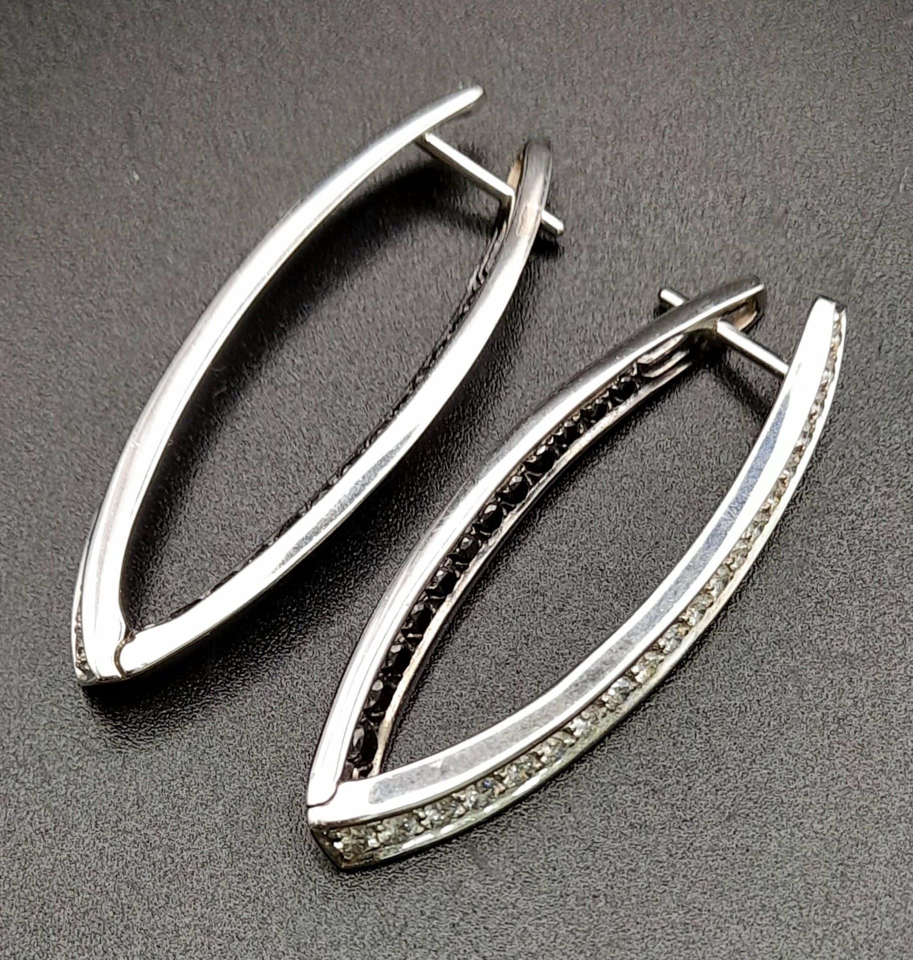 A Pair of Designer Palmiero 18K White Gold, Black and White Diamond Elongated Hoop Earrings. 0. - Image 5 of 9