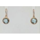 A Pair of 9K Yellow Gold Blue Topaz Earrings. Faceted topaz circles. 1.46g total weight.