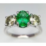 A WGI certified 18K white gold emerald and diamond trilogy ring. Oval mixed cut natural emerald