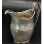 An Antique George III Sterling Silver Cream Jug. Hallmarks for London 1800. 11cm tall. 93.3g weight.