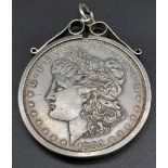 AN 1884 SILVER DOLLARIN A SILVER PENDANT SETTING . 31.2gms (GOOD DEFINITION FOR AGE)