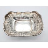 A SOLID SILVER SMALL DISH WITH PIRCED DESIGN DATED 1915 . 44.8gms 10 x 7CMS APPROX
