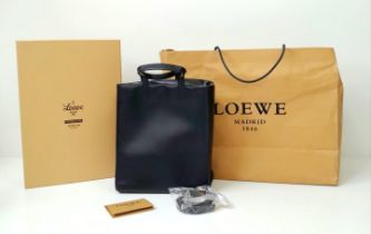 A Luxury Loewe Black Leather Papelle Tote Bag. Soft black leather exterior. Red textile interior