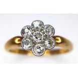 AN 18K GOLD DIAMOND CLUSTER RING IN FLORAL FORM , WITH A CHESTER HALLMARK. 2.5gms size K
