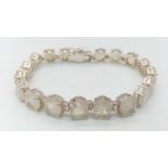 A Moonstone Gemstone Bracelet set in 925 Silver. 18 oval-cut moonstones. 19.83g total weight.