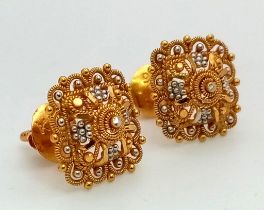 A Pair of Asian Inspired 22k Yellow and White Gold Earrings. 3.4g total weight. Comes with fitted
