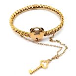 AN ANTIQUE 15K GOLD LINK BANGLE WITH HEART PADLOCK , KEY AND SAFETY CHAIN . 12.9gms