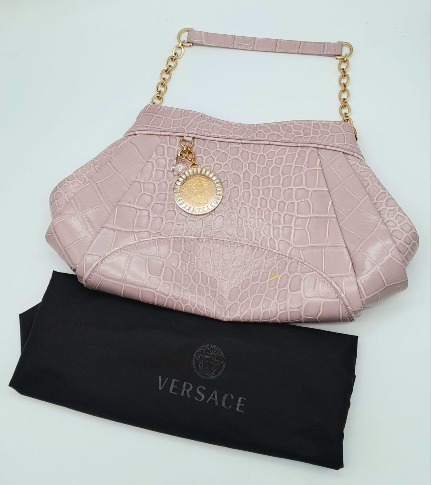 A VERSACE OLD ROSE CROC EMBOSSED LEATHER SHOULDER BAG. GOLD TONE HARDWARE INCLUDING VERSACE CHARM