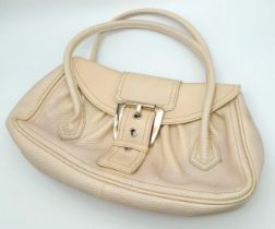 A Celine Cream Leather Handbag. Grained leather exterior with silver-tone belt buckle. Black textile
