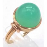 An 18k Yellow Gold Green Jade Cabochon Ring. A mesmerising dome of luscious pale green jade. Size
