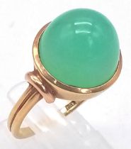 An 18k Yellow Gold Green Jade Cabochon Ring. A mesmerising dome of luscious pale green jade. Size