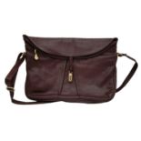 A Vintage Burgundy Leather Handbag. Burgundy leather with large exterior pocket. Gilded touches.