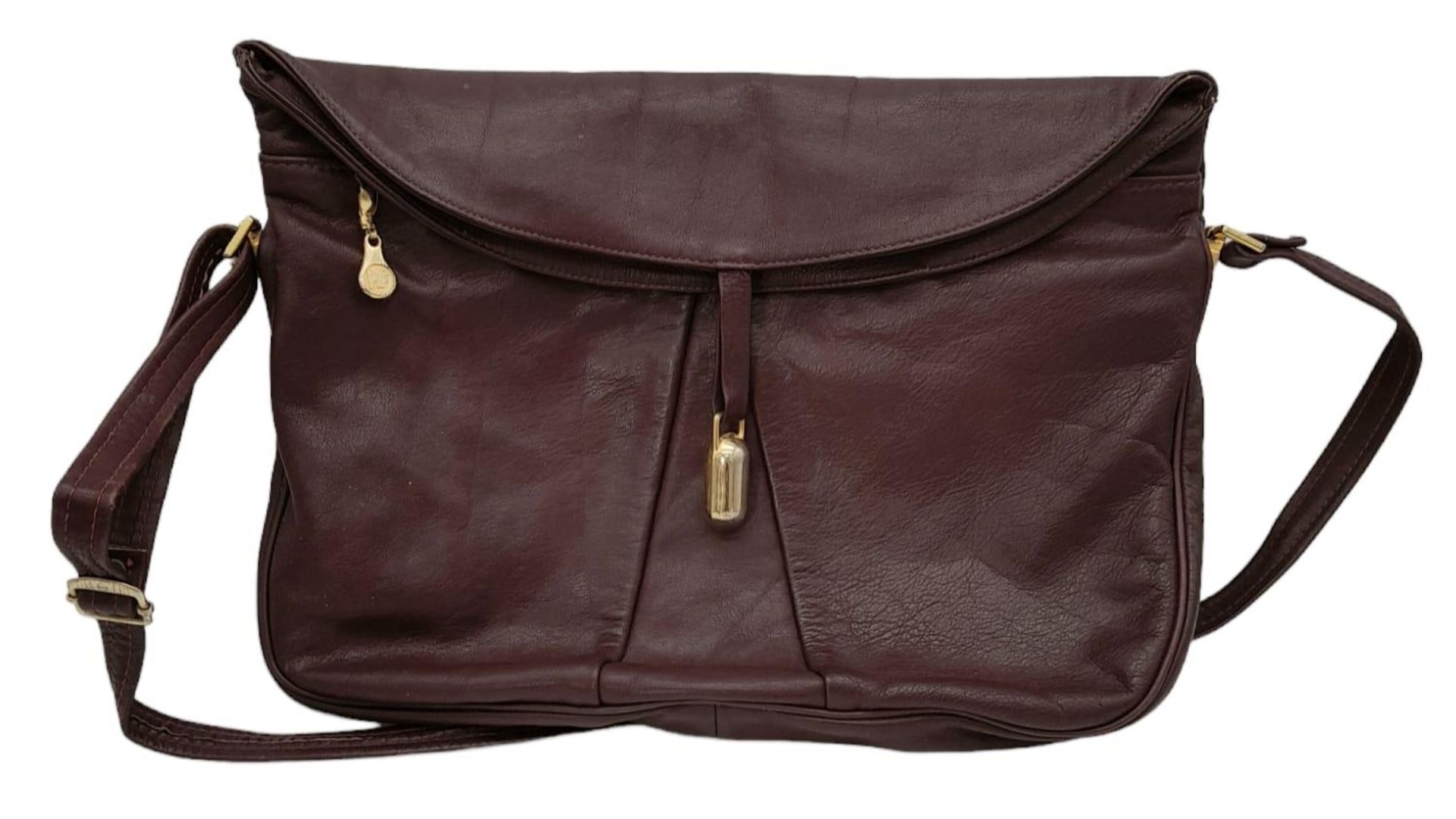 A Vintage Burgundy Leather Handbag. Burgundy leather with large exterior pocket. Gilded touches.