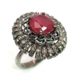 An Art Deco Style 5.90ct Ruby Ring with 1.60ct of Diamond Accents. Set in 925 silver. Size P.