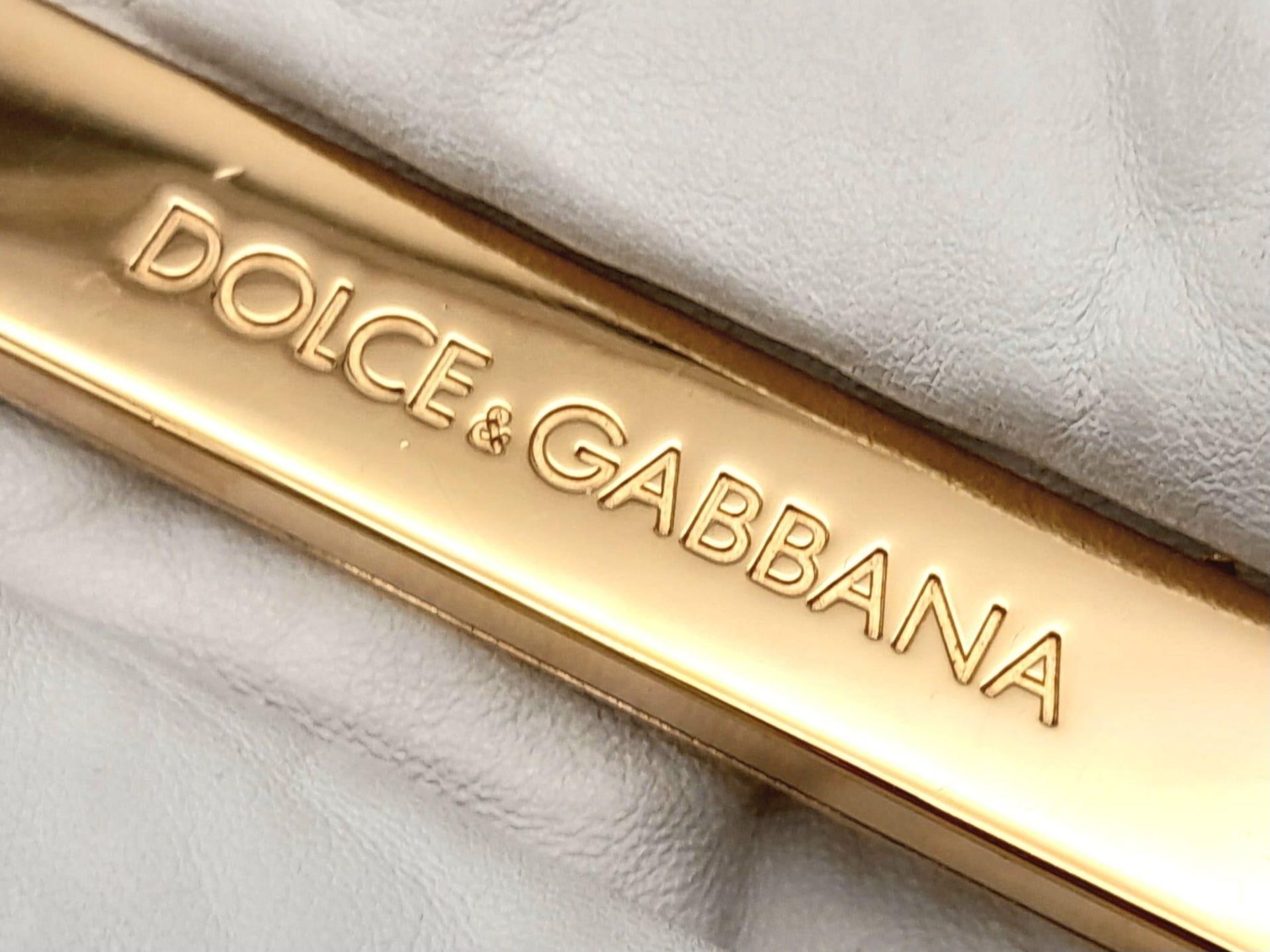 A Dolce and Gabbana Vintage Anniversary Handbag. White leather exterior with twin pockets. Gold tone - Image 7 of 10