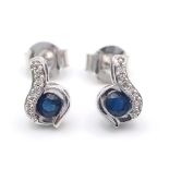 A Pair of 9K White Gold, Sapphire and Diamond Swirl Earrings. 1.45g total weight.