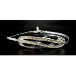 A very elegant, sterling silver bracelet with an eternity knot studded with clear stones. Weight: