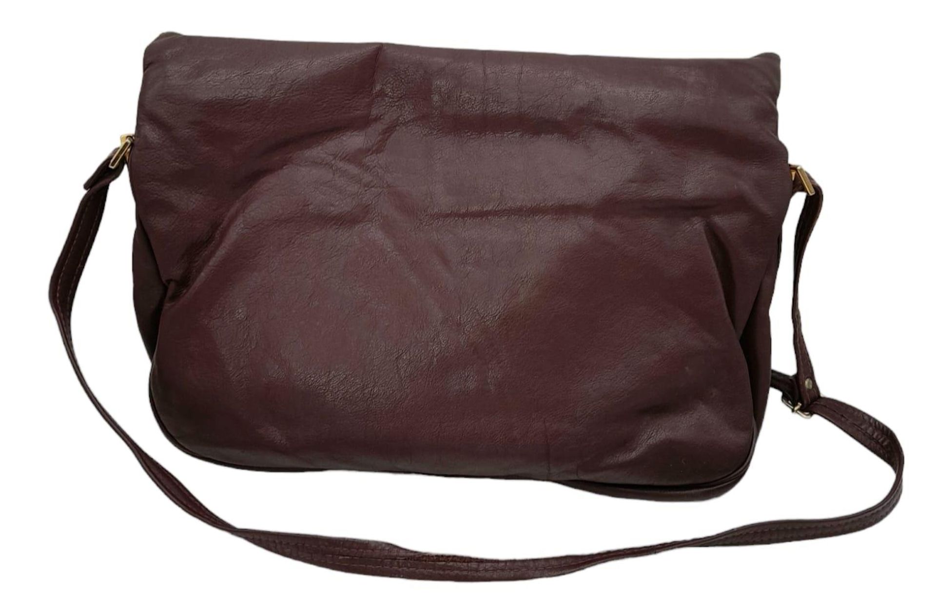 A Vintage Burgundy Leather Handbag. Burgundy leather with large exterior pocket. Gilded touches. - Image 2 of 9