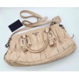 A PRADA BEIGE NAPPA LEATHER GAUFRE POMICE TOTE BAG. SILVER TONE HARD WEAR INCLUDING BUCKLE DETAIL.