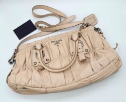 A PRADA BEIGE NAPPA LEATHER GAUFRE POMICE TOTE BAG. SILVER TONE HARD WEAR INCLUDING BUCKLE DETAIL.