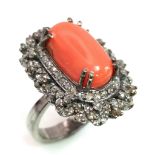 A 5.20ct Red Coral Ring with 1.35ct of Diamond Accents. Set in 925 Silver. Size L. Comes with a