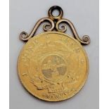 An 1898 22k Gold South African One Pond Coin. Attached to a 9k gold pendant frame. EF - But please