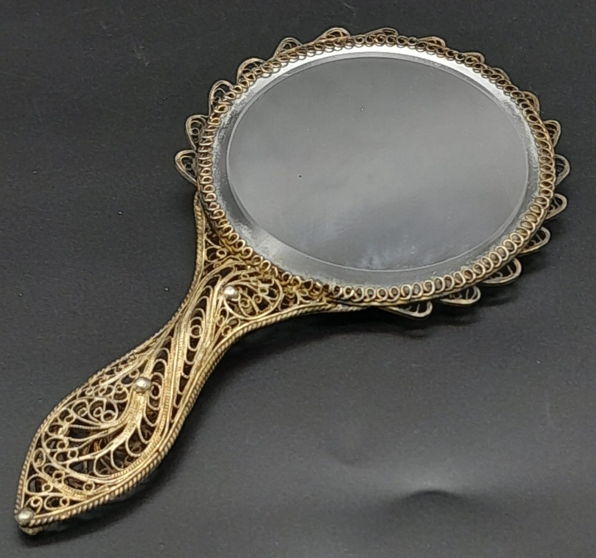 An Antique Silver Filigree Hand Mirror 13cm Length, 67mm Width.