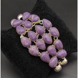 A glorious, white metal (untested), bracelet with numerous, oval charoite cabochons. In a