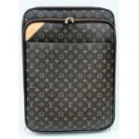 A Louis Vuitton Monogram Pegase Suitcase. Durable leather exterior. Front compartment with zipper,
