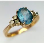 A 9k yellow gold blue topaz and clear stone ring. 3.2g total weight. Size O (topaz: 1.60ct)