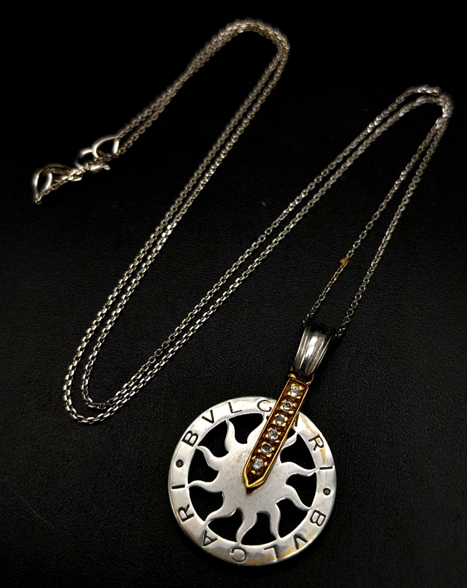 An 18 K white gold chain necklace with a BULGARI 18 K white and yellow gold pendant carrying six
