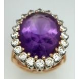 AN 18K YELLOW GOLD DIAMOND & PURPLE STONE ( BELIEVED TO BE AMETHYST ) COCKTAIL RING, WITH A LARGE