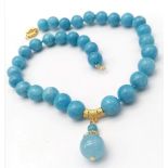 A Blue Aquamarine Beaded Necklace with Hanging Pendant. Gilded accents and clasp. 12mm beads. 42cm