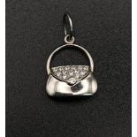 A Tiffany and Co. Diamond and Platinum Handbag Pendant. 17mm. 2.5g total weight.