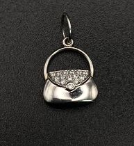 A Tiffany and Co. Diamond and Platinum Handbag Pendant. 17mm. 2.5g total weight.