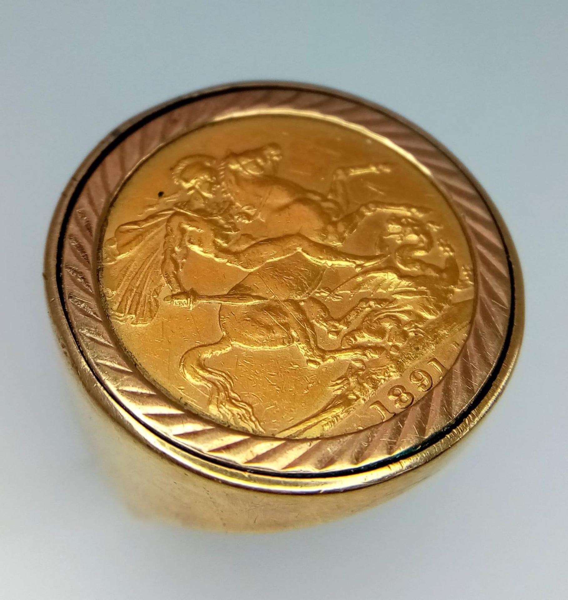 A 22K GOLD VICTORIAN SOVEREIGN DATED 1891 SET IN A 9K GOLD RING . 15.4gms size T