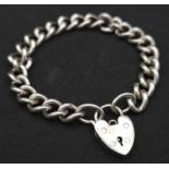 A Sterling silver chunky charm bracelet with heart padlock fastening. 31.6g