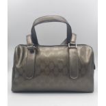 A Gucci Metallic Grey Boston Bag. Patent monogram leather exterior. Brown textile interior with