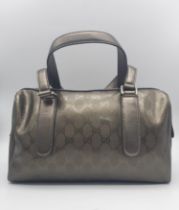 A Gucci Metallic Grey Boston Bag. Patent monogram leather exterior. Brown textile interior with