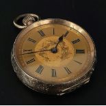 An Antique 9K Gold Ladies Fob Watch. Engraved case with empty cartouche to centre. Richly gilded