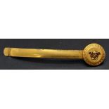 A genuine VERSACE gold plated tie holder. Length: 7 cm, with original presentation inner and outer