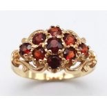 A Vintage 9K Yellow Gold Garnet Cluster Ring. Nine faceted garnets. Size S. 3.15g total weight.