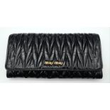 A Miu Miu Black Matelassé Leather Purse/Wallet. Gold logo on the front flap with two press stud