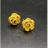 A PAIR OF 9K GOLD STUD EARRINGS IN FLORAL FORM . 1.8gms