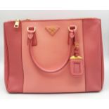 A Prada Two-Tone Pink Galleria Bag. Saffiano leather exterior. Features expandable side wings with